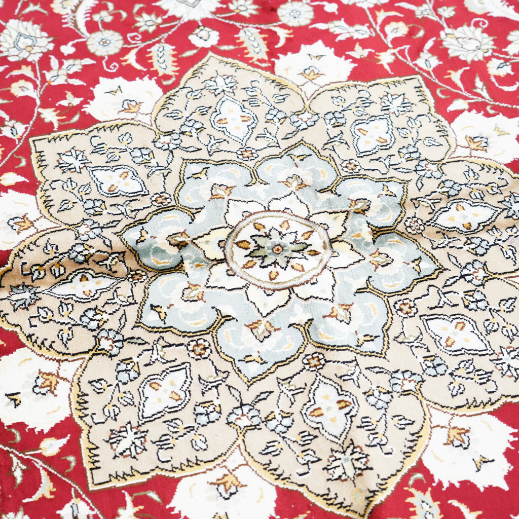 Close up of detailed flower on Qom Ruby Silk Rug