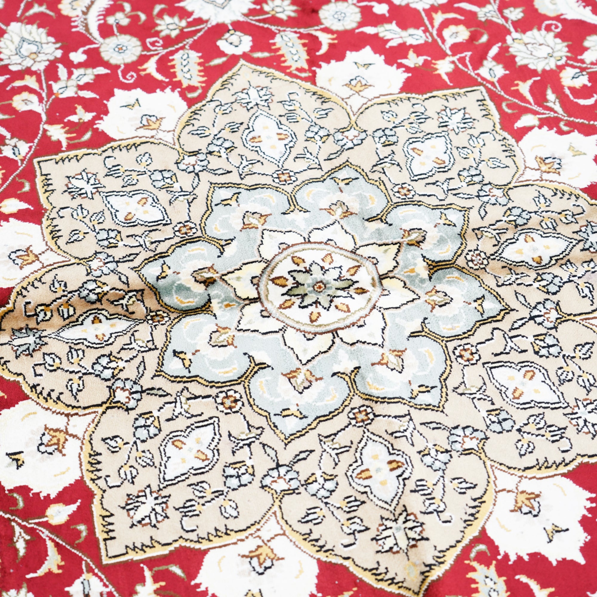 Close up of detailed flower on Qom Ruby Silk Rug