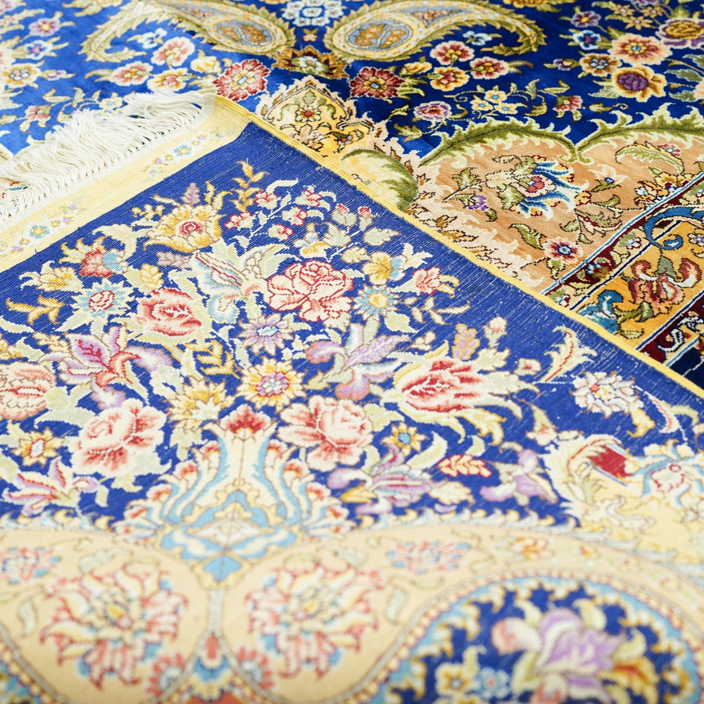 Close-up of a colorful patterned fabric with floral and paisley designs.