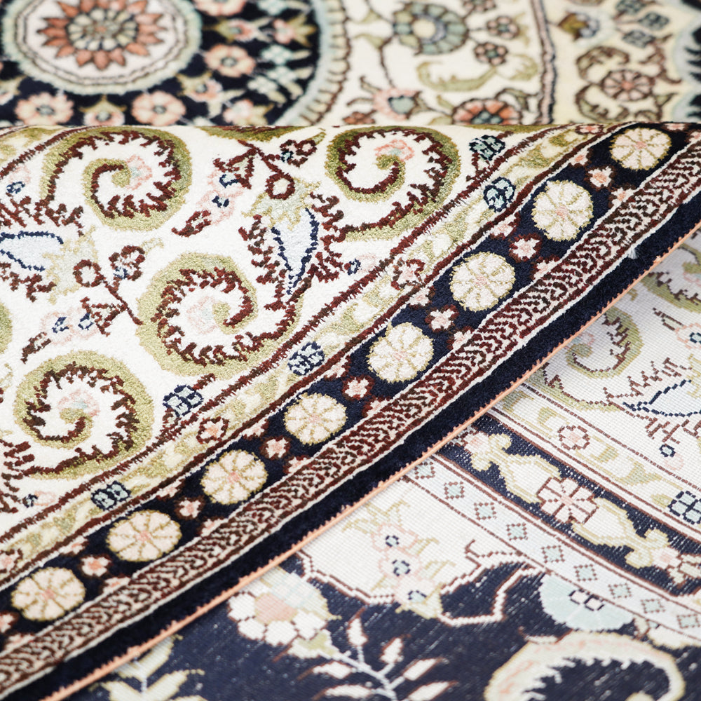 Close-up of intricately designed patterned rugs with floral and geometric elements.