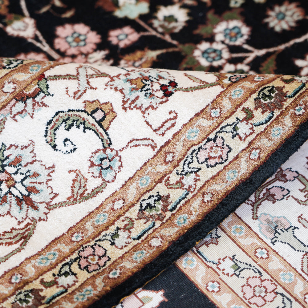 End fold of The Tabriz Noir Garden Rug 